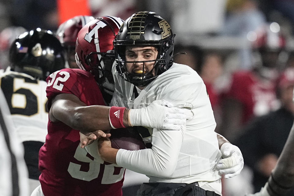 Purdue's Aidan O'Connell, right, is sacked by Indiana's Alfred Bryant (92) during the second half of an NCAA college football game, Saturday, Nov. 26, 2022, in Bloomington, Ind. (AP Photo/Darron Cummings)