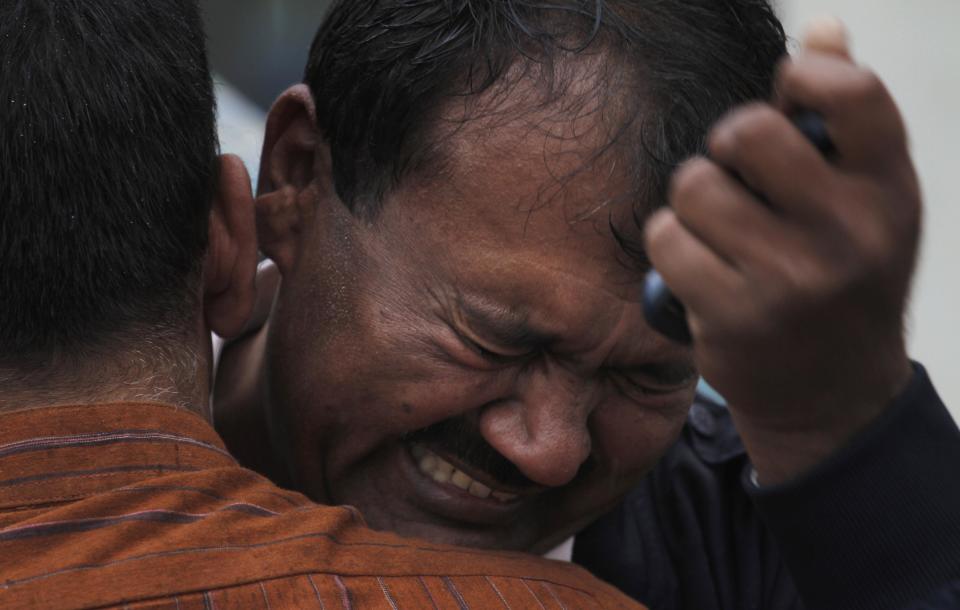 A Pakistani man mourns outside a hospital's morgue, where the bodies of victims of a twin suicide bombing are, in Islamabad, Pakistan, Monday, March 3, 2014. Two suicide bombers blew themselves up at a court complex in the Pakistani capital on Monday, killing nearly a dozen and wounding scores in a rare terror attack in the heart of Islamabad, officials said. (AP Photo/Anjum Naveed)