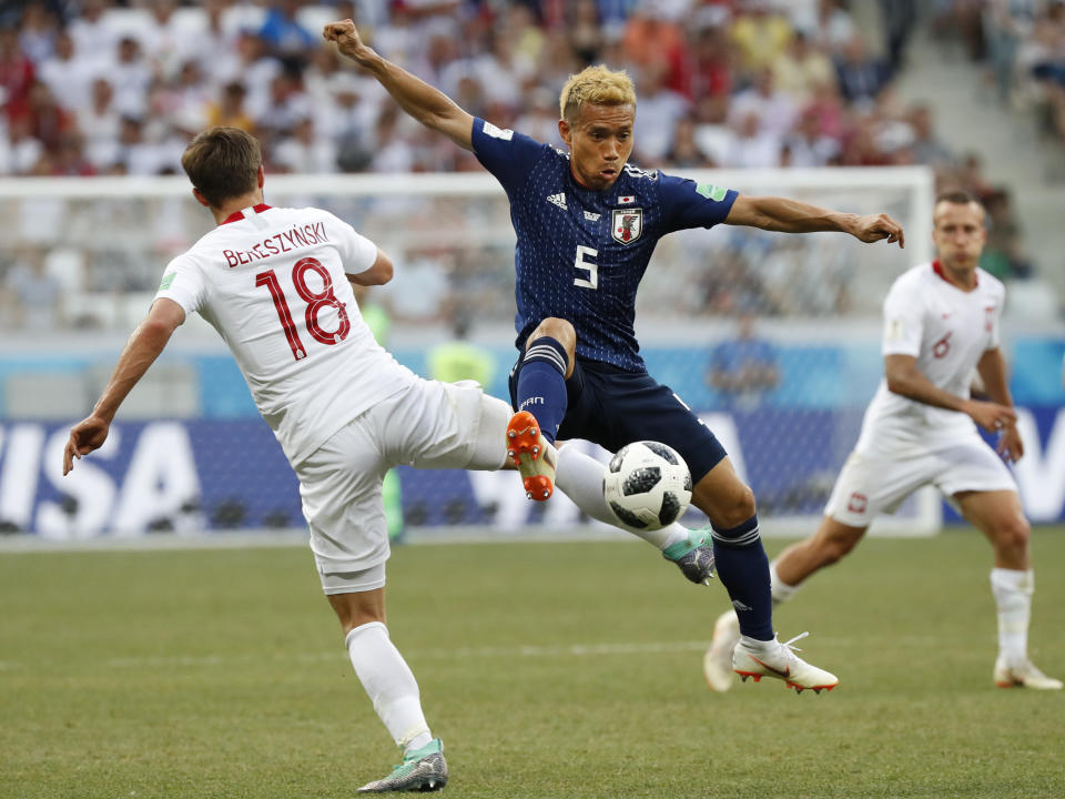 Japan’s Yuto Nagatomo, center, and Poland’s Bartosz Bereszynski vie for the ball during the group H match between Japan and Poland at the 2018 soccer World Cup at the Volgograd Arena in Volgograd, Russia, Thursday, June 28, 2018. (AP Photo/Eugene Hoshiko)