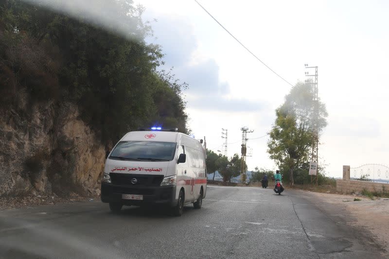 An ambulance drives trough the village of Ain Qana, in Lebanon