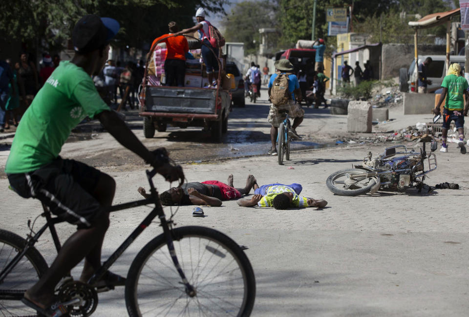 The bodies of two inmates lie on the street outside the Croix-des-Bouquets Civil Prison after an attempted breakout, in Port-au-Prince, Haiti, Thursday, Feb. 25, 2021. At least seven people were killed and one injured after eyewitnesses told The Associated Press that several inmates tried to escape from the prison in Haiti’s capital. (AP Photo/Dieu Nalio Chery)