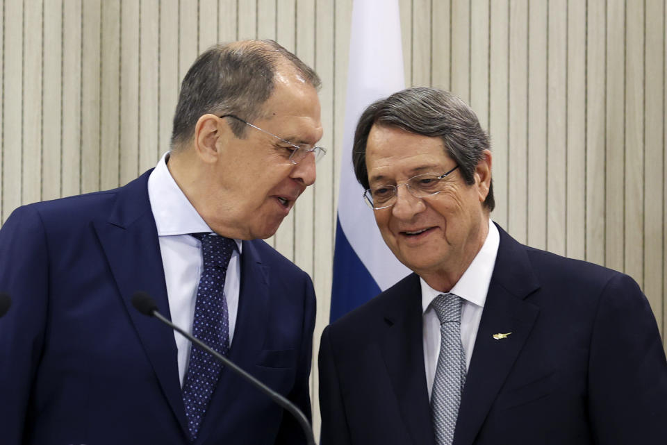In this handout photo released by the Russian Foreign Ministry Press Service, Russian Foreign Minister Sergey Lavrov, left, and Cypriot President Nicos Anastasiades talk to each other during a joint news conference following their talks at the Presidential Palace in Nicosia, Cyprus, Tuesday, Sept. 8, 2020. (Russian Foreign Ministry Press Service via AP)