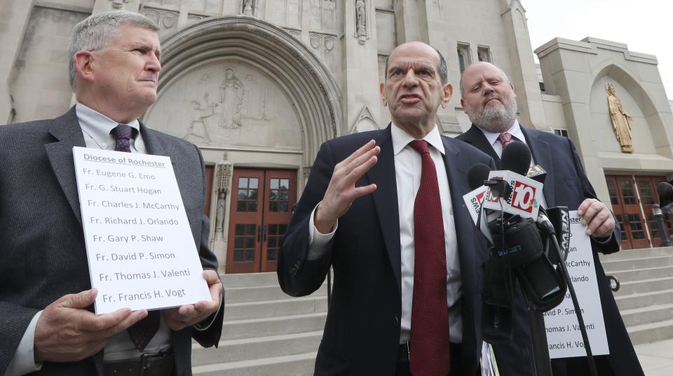 Mitchell Garabedian, Boston attorney, center, flanked