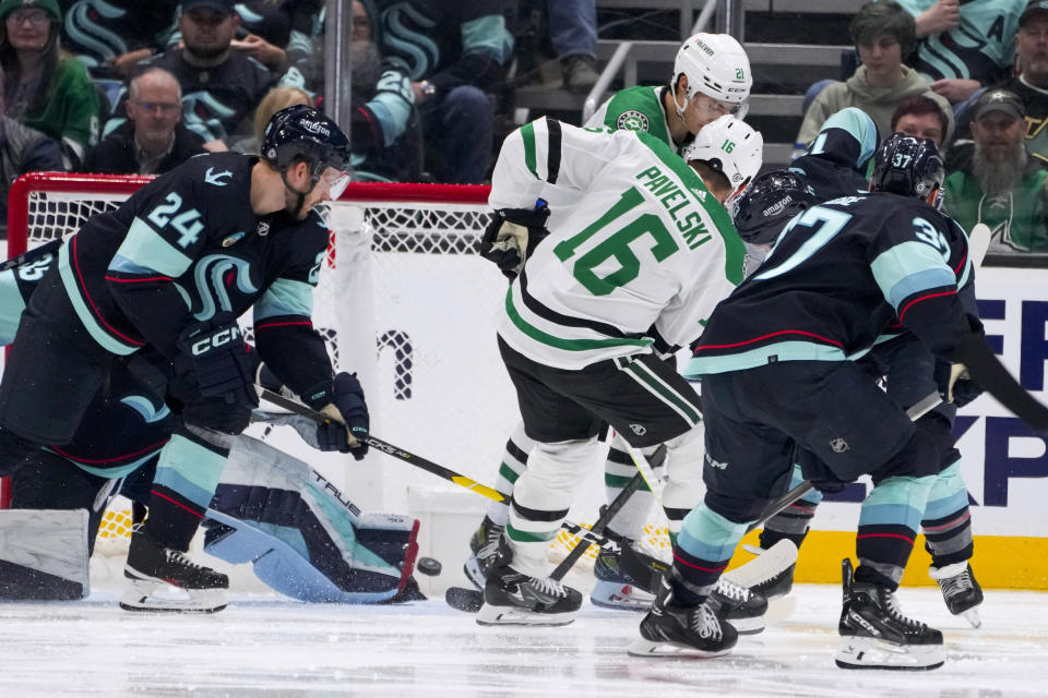 Dallas Stars center Joe Pavelski (16) scores a goal as Seattle Kraken defenseman Jamie Oleksiak (24) and goaltender Joey Daccord, defend during the third period of an NHL hockey game Saturday, March 30, 2024, in Seattle. The Stars won 3-0. (AP Photo/Lindsey Wasson)