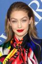 <p>To confidently wear bold red lipstick like Gigi Hadid, start by applying a balm, such as Elizabeth Arden's <a rel="nofollow noopener" href="https://www.elizabetharden.co.uk/eight-hour-cream-lip-protectant-stick-sunscreen-spf-15-UK10014253000.html?cgid=lip-care" target="_blank" data-ylk="slk:Eight Hour Protectant Stick;elm:context_link;itc:0;sec:content-canvas" class="link ">Eight Hour Protectant Stick</a>, £20, to moisturise your lips. Then, define them, with a particular focus on your cupid's bow, using Revlon's <a rel="nofollow noopener" href="http://www.boots.com/revlon-colorstay-lipliner-10178389" target="_blank" data-ylk="slk:ColorStay Lip Liner in Red;elm:context_link;itc:0;sec:content-canvas" class="link ">ColorStay Lip Liner in Red</a>, £4.19. Finally, for a precise finish, apply your chosen true red shade, such as Maybelline's <a rel="nofollow noopener" href="https://www.superdrug.com/Make-Up/Lips/Lipstick/Maybelline-Color-Sensational-Lipstick-Pleasure-Me-Red/p/222167" target="_blank" data-ylk="slk:Color Sensational in Pleasure Me Red;elm:context_link;itc:0;sec:content-canvas" class="link ">Color Sensational in Pleasure Me Red</a>, £6.99, using Mac's <a rel="nofollow noopener" href="https://www.maccosmetics.co.uk/product/13806/295/products/brushes-tools/brushes/lip-brushes/316-lip-brush?cm_mmc=GoogleBase-_-ShoppingFeed-_-Brushes-_-LipBrushes&gclid=CjwKCAjw6djYBRB8EiwAoAF6oUSH4g7CvV5nC41W6tWYpE5Kv5QHhxsei60gr3zIX2rMV3sq3ccVMhoCCbgQAvD_BwE&gclsrc=aw.ds&dclid=CKLX4uWpvNsCFY9j0wodU64KOg" target="_blank" data-ylk="slk:Lip Brush;elm:context_link;itc:0;sec:content-canvas" class="link ">Lip Brush</a>, £16.50, rather than straight from the bullet.</p>