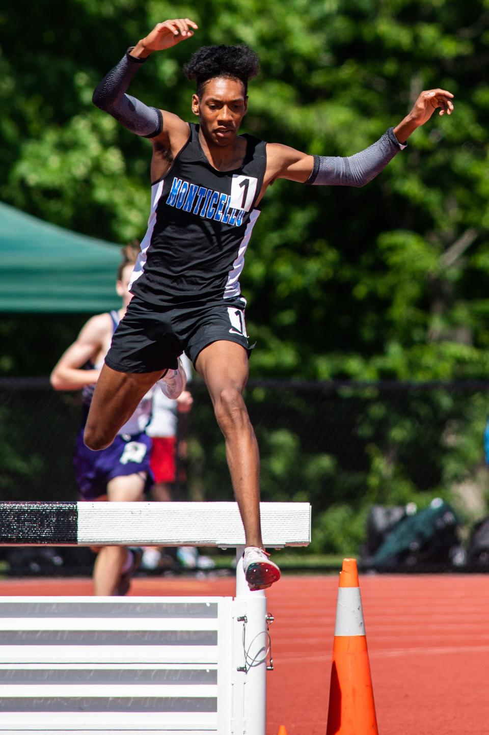 Monticello's Evan Waterton competes in the boys 3,000 meter steeplechase race during the  state qualifying track and field meet at Goshen High School on Friday, June 3, 2022.