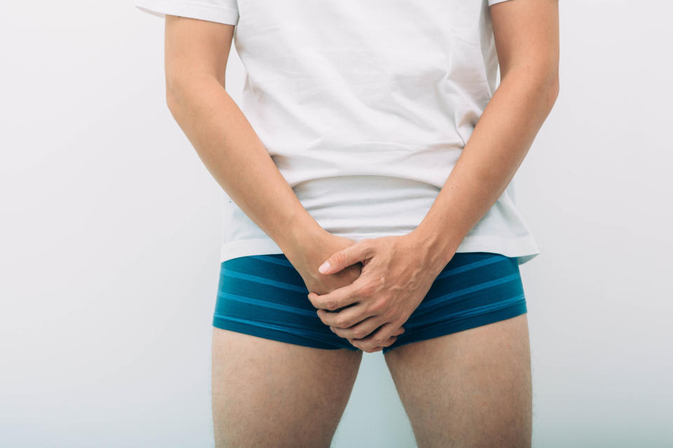 man wearing underpants holding genitals prostate problem. Men's health, venereologist, sexual disease