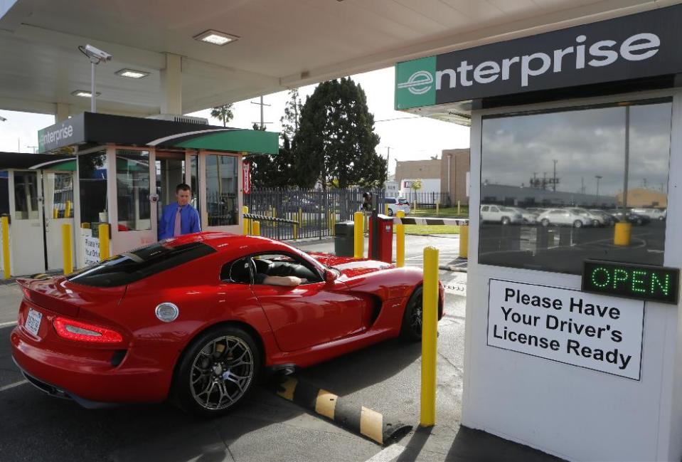 In this Wednesday, March, 26, 2014 photo, A rented 2013 Dodge Viper checks out at the Enterprise Exotic Car Collection showroom near Los Angeles International Airport. (AP Photo/Damian Dovarganes)