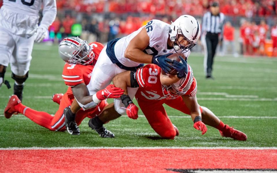 Ohio State defenders can’t stop Penn State tight end Brenton Strange as he dives into the end zone for a touchdown in the first quarter of the game on Saturday, Oct. 30, 2021 at Ohio Stadium.