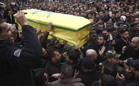 Hezbollah members and supporters carry the coffin of Jihad Moughniyah during his funeral in Beirut's suburbs January 19, 2015. REUTERS/Khalil Hassan
