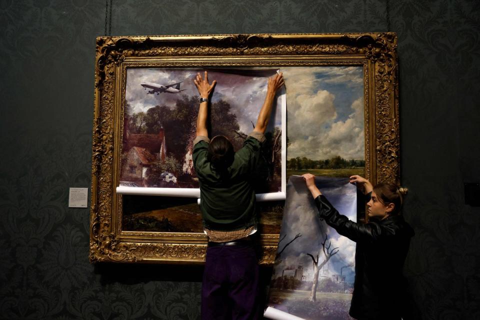 Activists from the 'Just Stop Oil' campaign group cover 'The Hay Wain' painting by English artist John Constable (AFP via Getty Images)