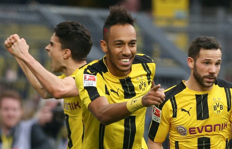 Dortmund's forward Pierre-Emerick Aubameyang (C) celebrates scoring the 3-1 with defender Marc Bartra (L) and midfielder Gonzalo Castro during the German First division Bundesliga football match against Bayer 04 Leverkusen March 4, 2017