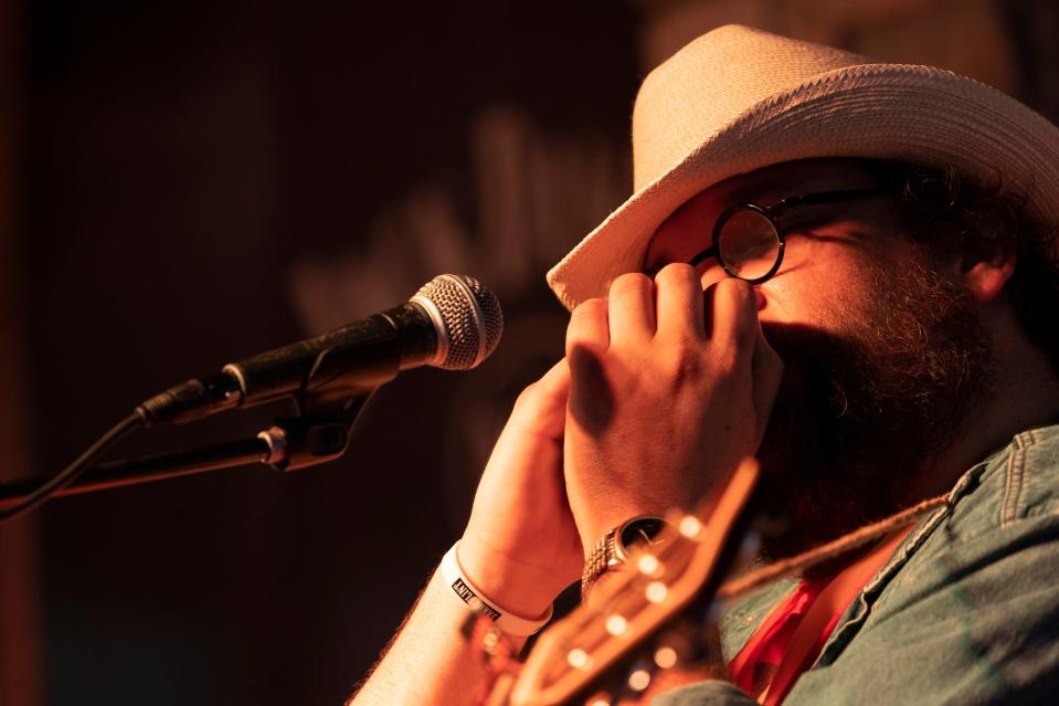 Buffalo Rogers plays the harmonica on the Outlaws stage at the Bob Childers' Gypsy Cafe in Stillwater, Okla. on Sunday, May 7, 2023.