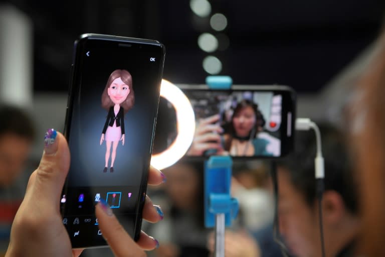 A woman checks a new Samsung Galaxy S9 mobile phone