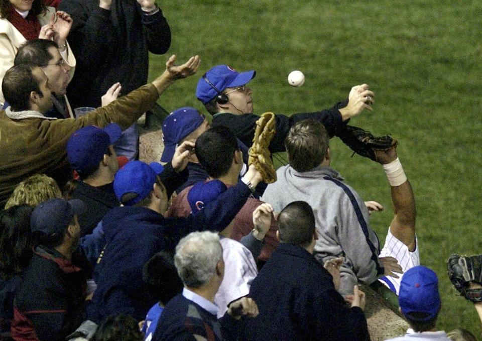 Steve Bartman, top center, prevents Chicago Cubs left fielder Moises Alou from catching a foul ball.