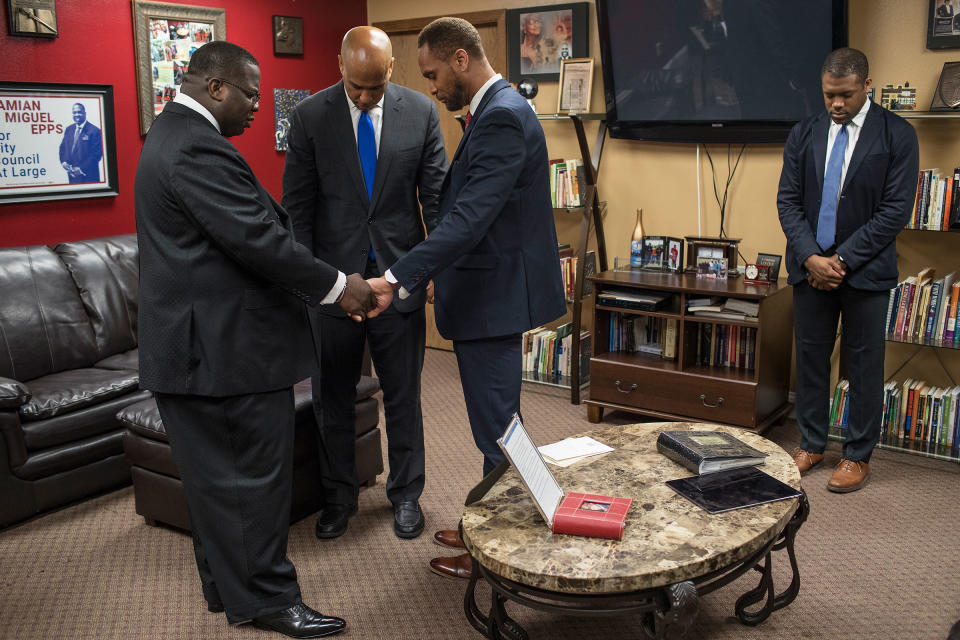 Pastor Dr. Damian Miguel Epps, Senator Cory Booker, and Linn County Supervisor Stacey Walker pray before the Youth Empowerment Day service at Mt. Zion Missionary Baptist Church in Cedar Rapids, Iowa on June 9. | Danny Wilcox Frazier—VII for TIME