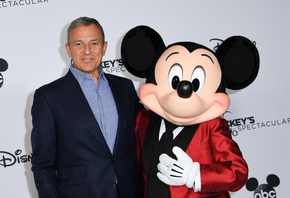 Walt Disney Company Chairman and CEO Robert A Iger poses with Mickey Mouse attends Mickey's 90th Spectacular at The Shrine Auditorium on October 6, 2018 in Los Angeles. (Photo by VALERIE MACON / AFP)        (Photo credit should read VALERIE MACON/AFP via Getty Images)