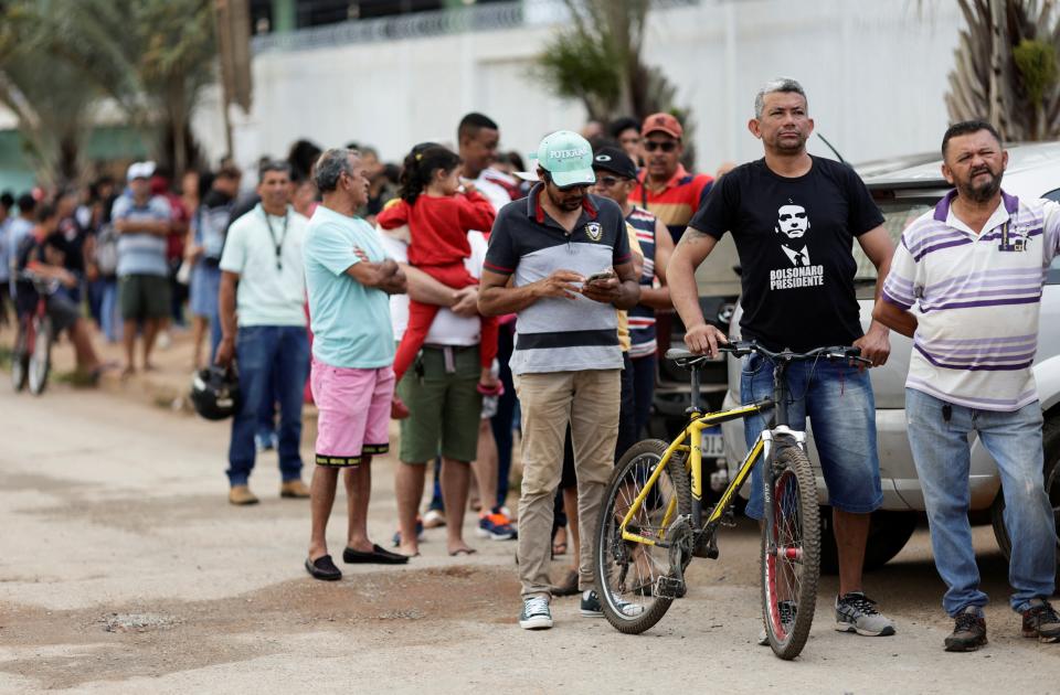 Voters queue at a polling station during a presidential a run-off election pitting President Jair Bolsonaro against former President Luiz InÃ¡cio Lula da Silva (REUTERS)