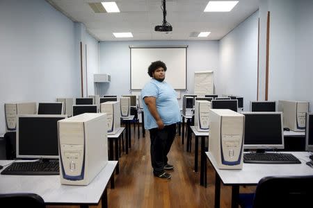 Kelvin Heredia poses for a picture at the academy where he's taking a computer course in Mostoles, outside Madrid, Spain, October 2, 2015. REUTERS/Susana Vera