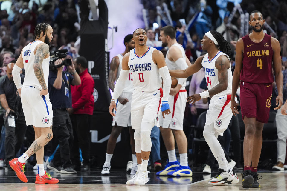 Los Angeles Clippers guard Russell Westbrook (0) celebrates after the team's victory over the Cleveland Cavaliers as Cavaliers center Evan Mobley (4) walks off during an NBA basketball game, Sunday, April 7, 2024, in Los Angeles. (AP Photo/Ryan Sun)