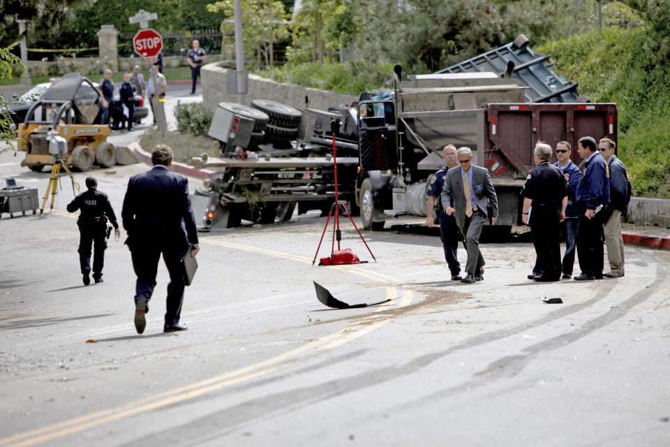 Police investigate the scene of a fatal police car accident, Friday, March 7, 2014 in Beverly Hills, Calif. A veteran Los Angeles police officer was killed and his rookie partner was critically injured Friday when their patrol car collided with a big rig on a residential street. The truck driver also was injured. (AP Photo/Los Angeles Times, Francine Orr, Pool)