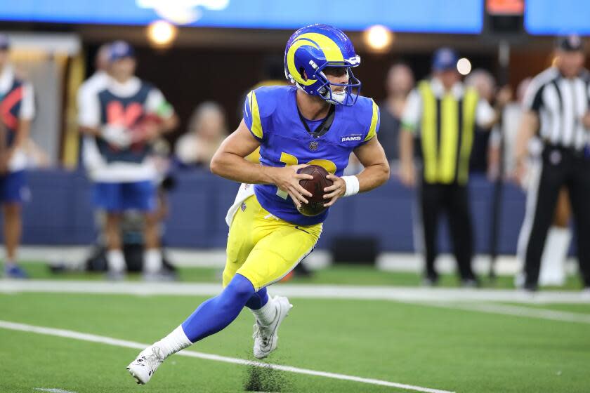 INGLEWOOD, CA - AUGUST 12: Los Angeles Rams quarterback Stetson Bennett (13) rolls out.