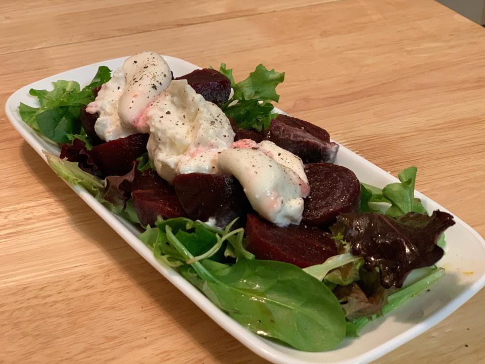 salad with cheese and beets on white plate