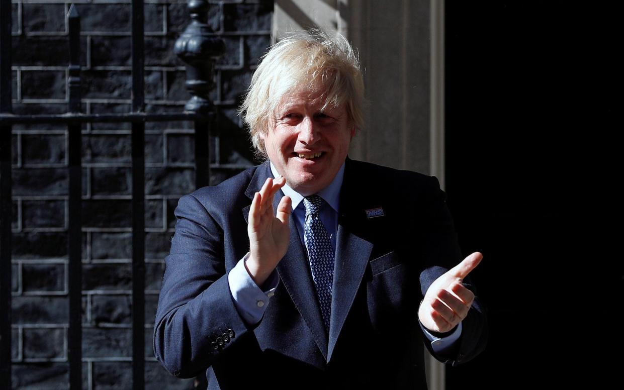 Britain's Prime Minister Boris Johnson applauds outside 10 Downing Street on the occasion of the 72nd anniversary of the NHS -  PETER NICHOLLS / Reuters