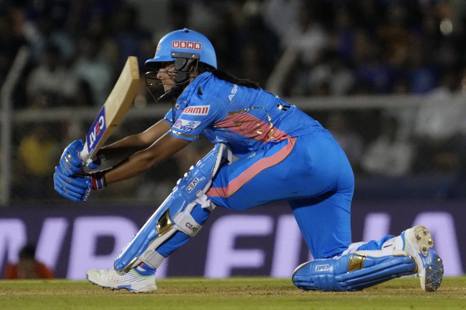 Mumbai Indians captain Harmanpreet Kaur plays a shot during during the Women's Premier League Twenty20 cricket final match between Delhi Captials and Mumbai Indians in Mumbai, India, Sunday, March 26, 2023. (AP Photo/Rajanish Kakade)