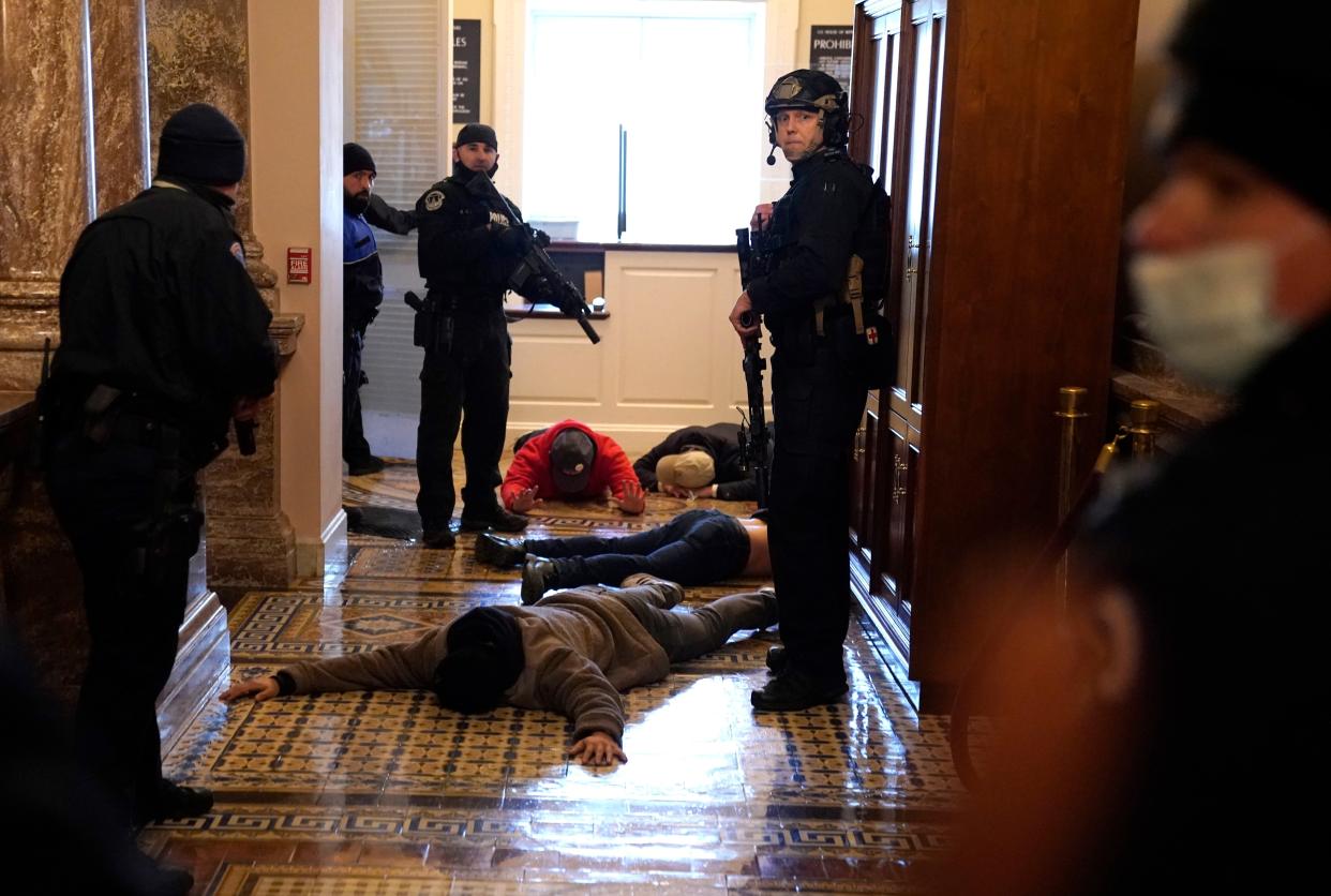 U.S. Capitol Police stand to detain protesters outside of the House Chamber during a joint session of Congress on January 06, 2021, in Washington, DC.