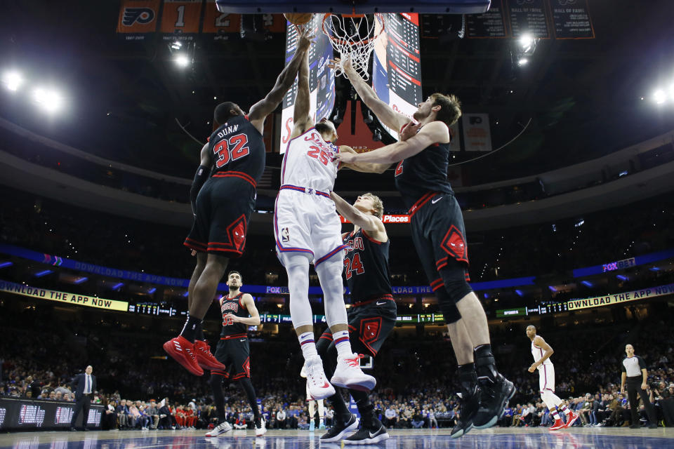 Philadelphia 76ers' Ben Simmons (25) leaps for a rebound against Chicago Bulls' Kris Dunn (32), Lauri Markkanen (24) and Luke Kornet (2) during the first half of an NBA basketball game, Friday, Jan. 17, 2020, in Philadelphia. (AP Photo/Matt Slocum)