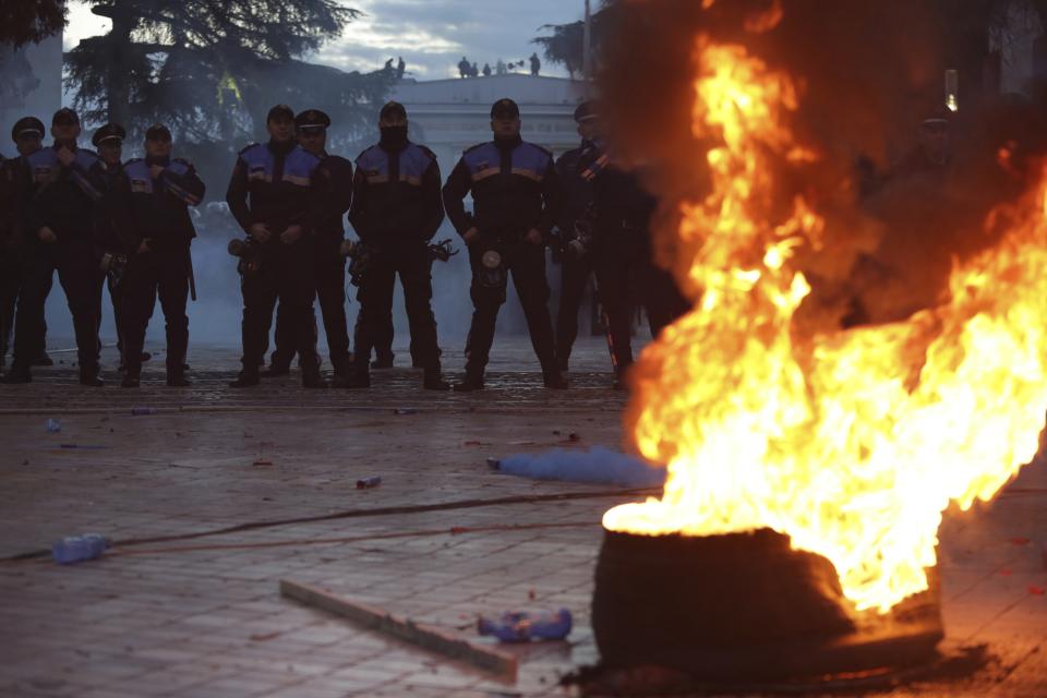 Policemen stand guard during an antigovernment rally in Tirana, Tuesday, Feb. 26, 2019. Albanian opposition supporters have surrounded the parliament building and are demanding that the government resign, claiming it's corrupt and has links to organized crime. (AP Photo/Hektor Pustina)