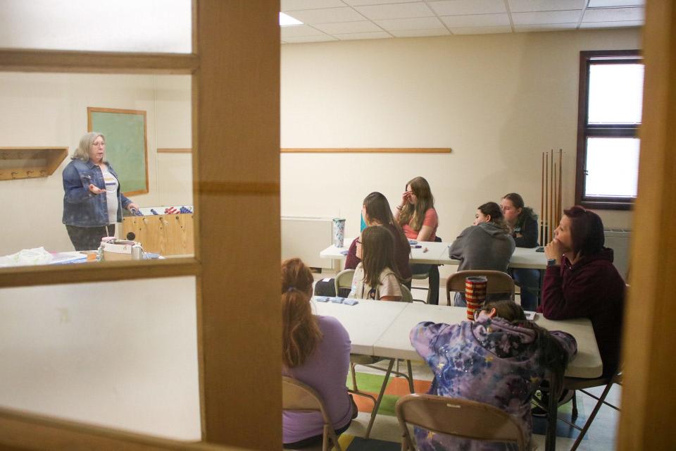 Lori Trow (left) talks to Girl Scouts in 6-10 grades about the importance of voting.