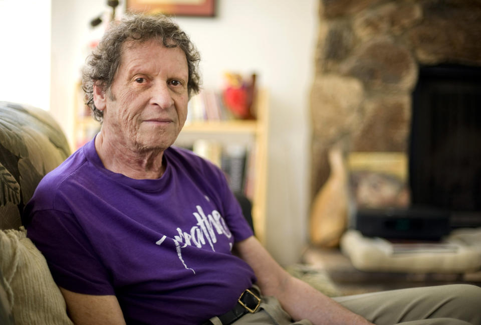 FILE - In this May 7, 2009, file photo, author, comedian and co-founder of the Yippie party as well as stand-up satirist, Paul Krassner, 77, poses for a photo at his home in Desert Hot Springs, Calif. Krassner, the publisher, author and radical political activist on the front lines of 1960s counterculture who helped tie together his loose-knit prankster group by naming them the Yippies, has died. His daughter, Holly Krassner Dawson, says Krassner died Sunday, July 21, 2019, at his home in Desert Hot Springs. He was 87. (AP Photo/Eric Reed, File)