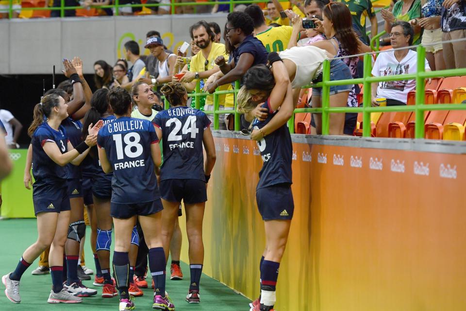 <p>Team players of France celebrate their win with family members after the women’s preliminaries Group B handball match Netherlands vs France on Day 1 of the Rio 2016 Olympic Games at Future Arena on August 6, 2016 in Rio de Janeiro, Brazil. (Photo by Pascal Le Segretain/Getty Images) </p>