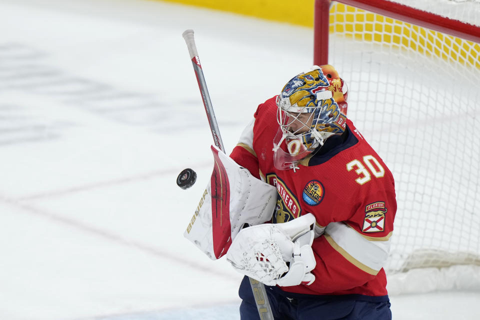 Florida Panthers goaltender Spencer Knight blocks a shot during the third period of an NHL hockey game against the Arizona Coyotes, Tuesday, Jan. 3, 2023, in Sunrise, Fla. (AP Photo/Wilfredo Lee)