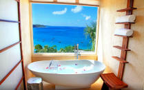 <p>This <a rel="nofollow noopener" href="https://www.expedia.co.uk/Anguilla-Hotels-CeBlue.h8316755.Hotel-Information" target="_blank" data-ylk="slk:villa on the Caribbean island of Anguilla;elm:context_link;itc:0;sec:content-canvas" class="link ">villa on the Caribbean island of Anguilla</a> comes with a private beach and full-service spa. But, really, you could just spend your entire time in that rose petal-filled bath tub overlooking the Caribbean sea. Dreamy. </p>