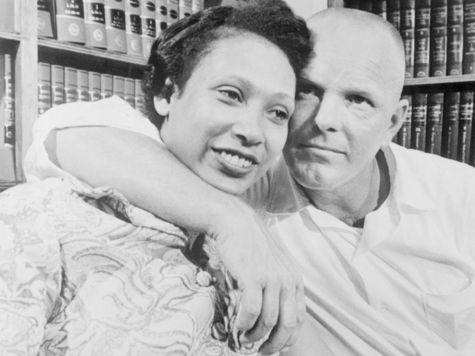 Black and white photo of Richard Loving embracing his wife, Mildred.