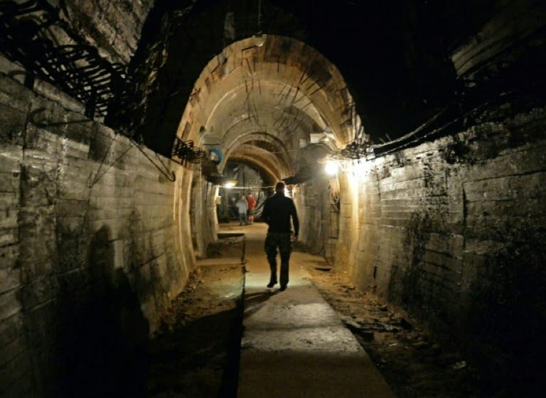 Men walk in underground galleries on August 28, 2015 under the Ksiaz castle in the area where a Nazi gold train is supposedly hidden in Walbrzych, Poland