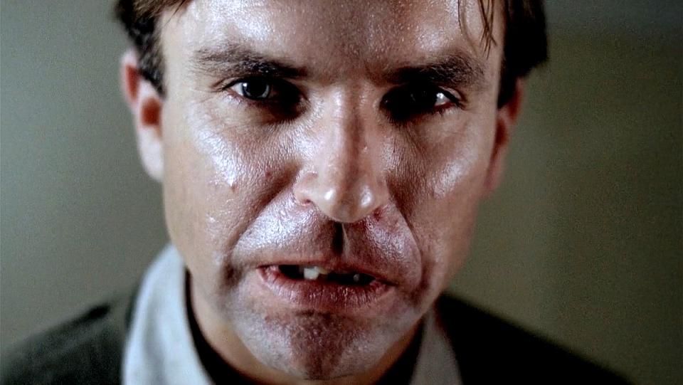 Sam Neill looks into the camera in a scene from Possession.
