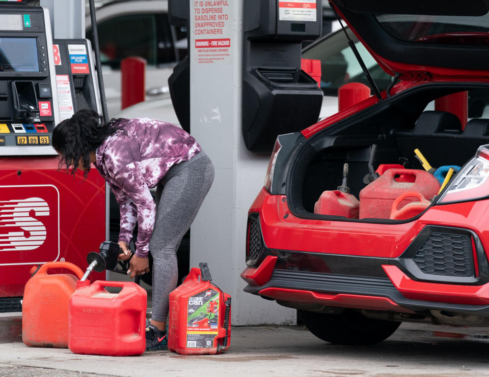 A woman fills up several gasoline cans Wednesday at a Speedway gas station in Benson, North Carolina. Most stations in the area along Interstate 95 were without fuel following the Colonial Pipeline hack.  (Photo: Sean Rayford/Getty Images)