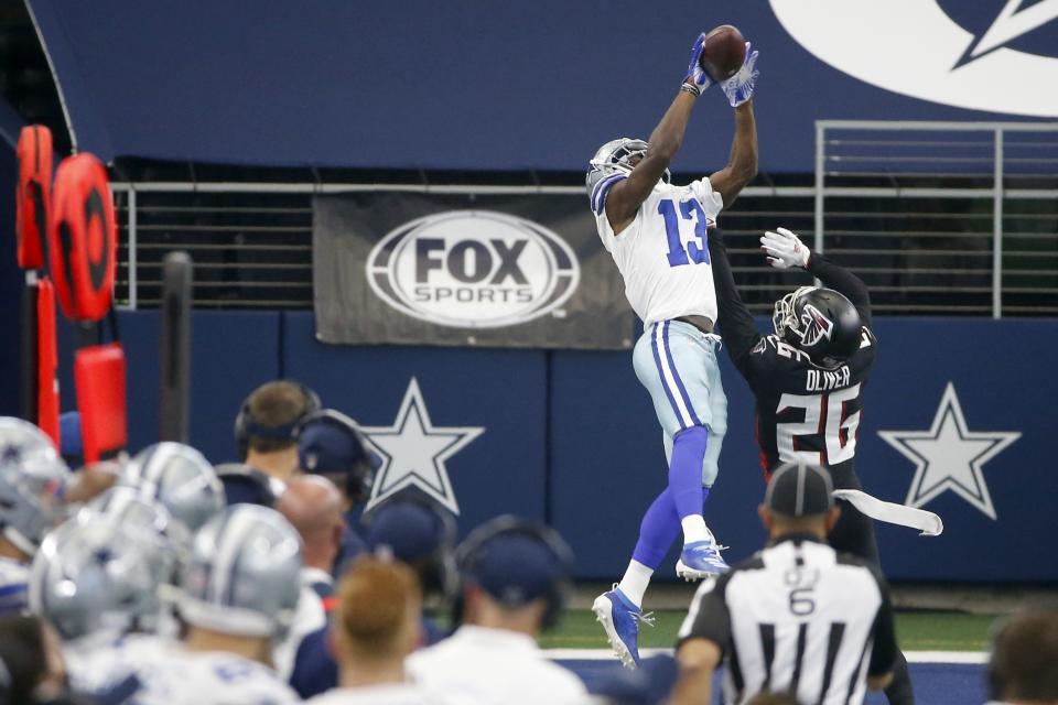 Dallas Cowboys wide receiver Michael Gallup (13) goes up to make a catch for a long gain in front of Atlanta Falcons' Isaiah Oliver (26) in the second half of an NFL football game in Arlington, Texas, Sunday, Sept. 20, 2020. (AP Photo/Ron Jenkins)