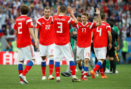 Soccer Football - World Cup - Group A - Russia vs Saudi Arabia - Luzhniki Stadium, Moscow, Russia - June 14, 2018 Russia's Ilya Kutepov, Aleksandr Golovin and Artem Dzyuba celebrate with team mates after the match REUTERS/Christian Hartmann