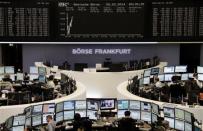 Traders are pictured at their desks in front of the DAX board at the Frankfurt stock exchange February 5, 2014. REUTERS/Remote/Stringer