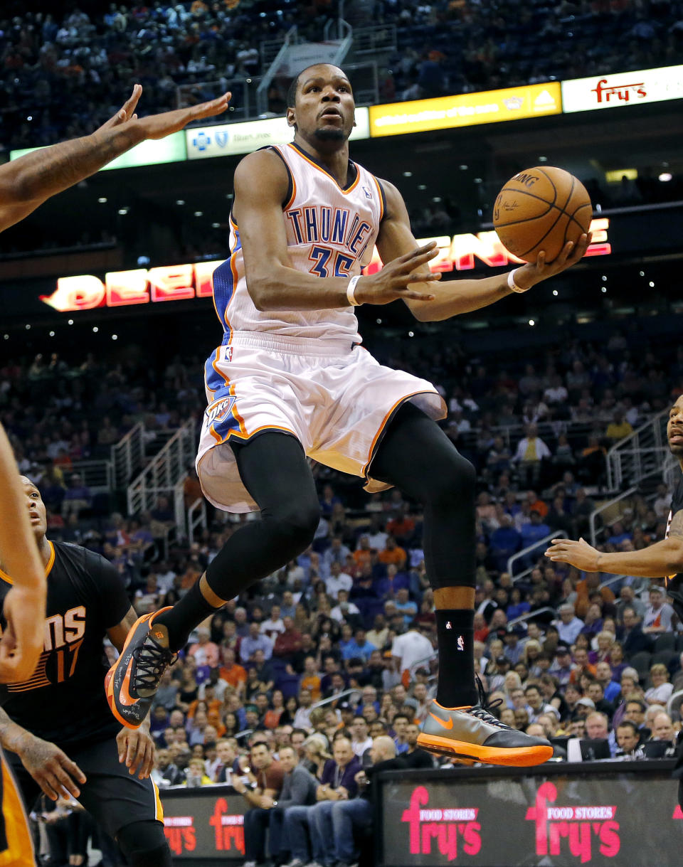 Oklahoma City Thunder forward Kevin Durant drives against the Phoenix Suns' during the first half of an NBA basketball game, Thursday, March 6, 2014, in Phoenix. (AP Photo/Matt York)