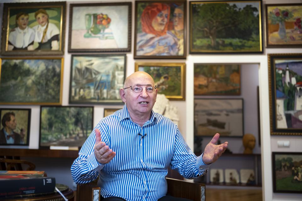 In this photo taken on Friday, March 15, 2019, Russian art collector Roman Babichev speaks during an interview with The Associated Press in his apartment in Moscow, Russia. Babichev has tracked down and collected works by many of Russia's forgotten modernist painters. (AP Photo/Alexander Zemlianichenko)