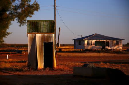 A dilapidated outdoor toilet known as a 'Dunny' can be seen near an abandoned house in the outback town of Stonehenge, in Queensland, Australia, August 13, 2017. REUTERS/David Gray