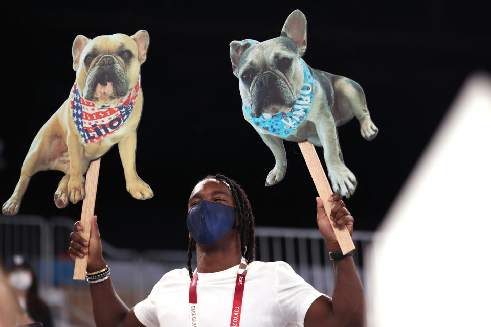 TOKYO, JAPAN – AUGUST 03: A member of the crowd holds signs with dogs during the Women’s Balance Beam Final on day eleven of the Tokyo 2020 Olympic Games at Ariake Gymnastics Centre on August 03, 2021 in Tokyo, Japan. (Photo by Laurence Griffiths/Getty Images)