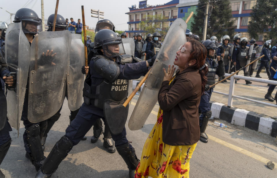 Policemen baton charge supporters of Rastriya Prajatantra Party, or national democratic party during a protest demanding a restoration of Nepal's monarchy in Kathmandu, Nepal, Tuesday, April 9, 2024. Riot police used batons and tear gas to halt thousands of supporters of Nepal's former king demanding the restoration of the monarchy and the nation's former status as a Hindu state. Weeks of street protests in 2006 forced then King Gyanendra to abandon his authoritarian rule and introduce democracy. (AP Photo/Niranjan Shrestha)