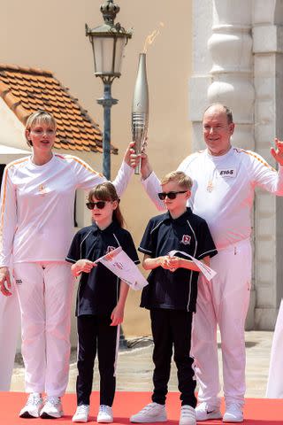 <p>Arnold Jerocki/Getty</p> Princess Charlene of Monaco (left) and Prince Albert II with their twins on June 18, 2024